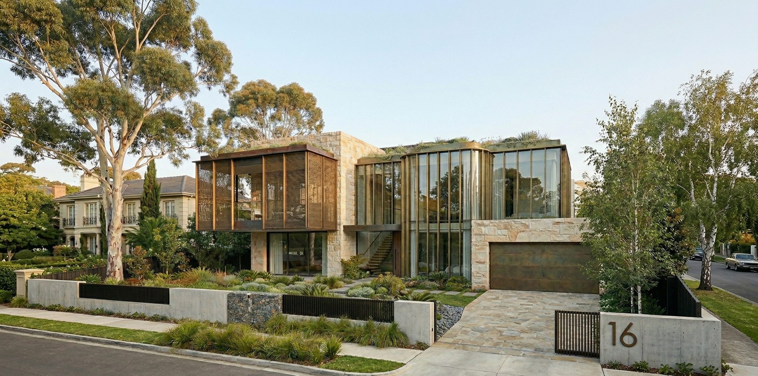 Residence with sandstone, bronze screens and curved glazing among eucalypts