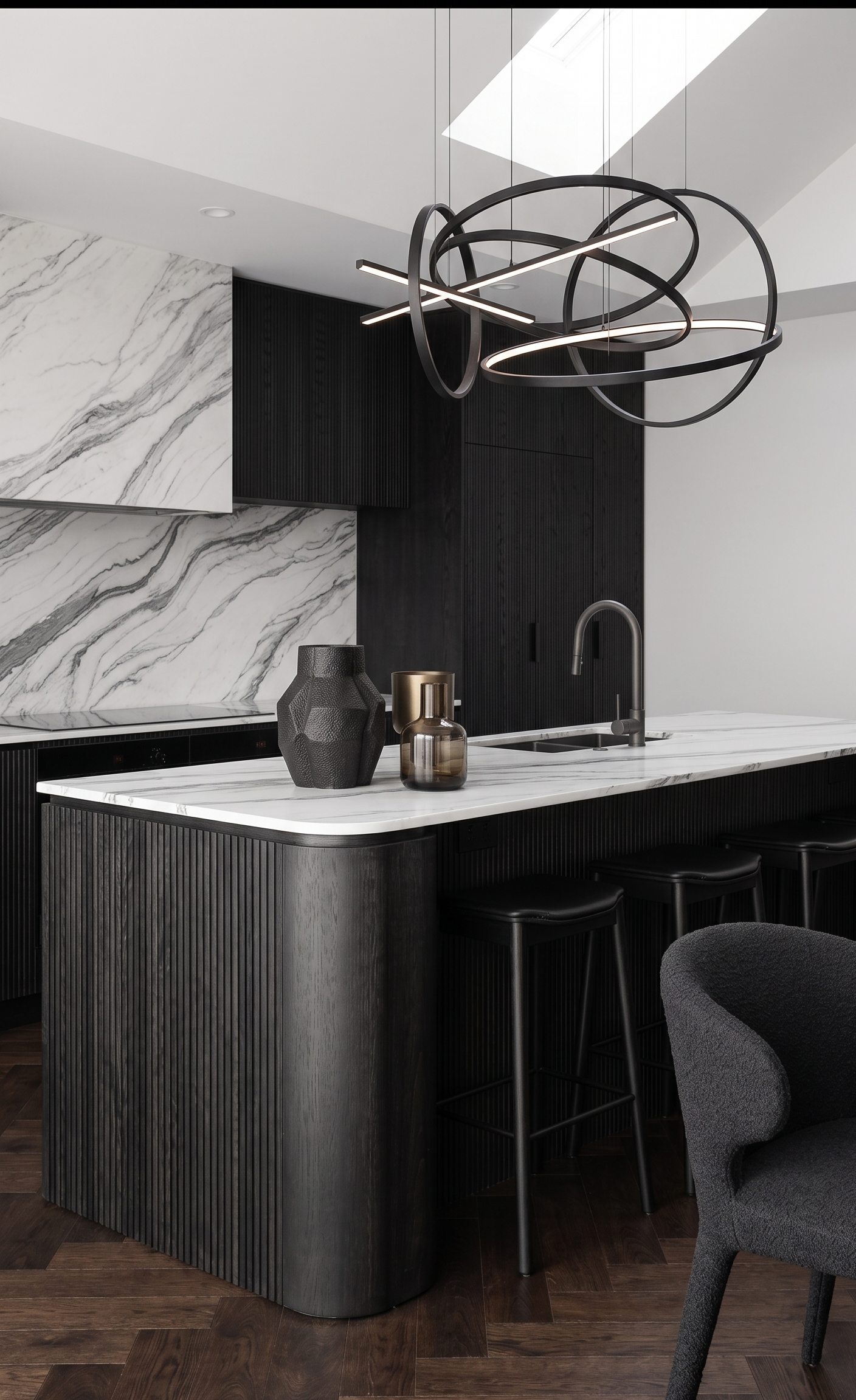 Black fluted timber kitchen island with marble and sculptural pendant